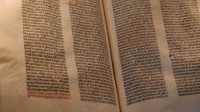 Offenes Buch mit altem Text und roten Markierungen