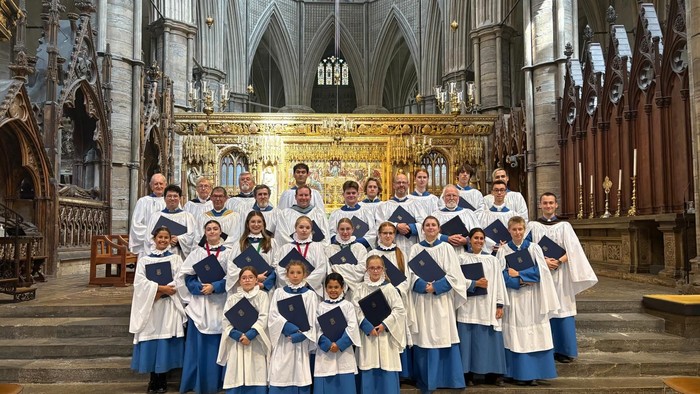 Group of children in choir robes posing in cathedral.