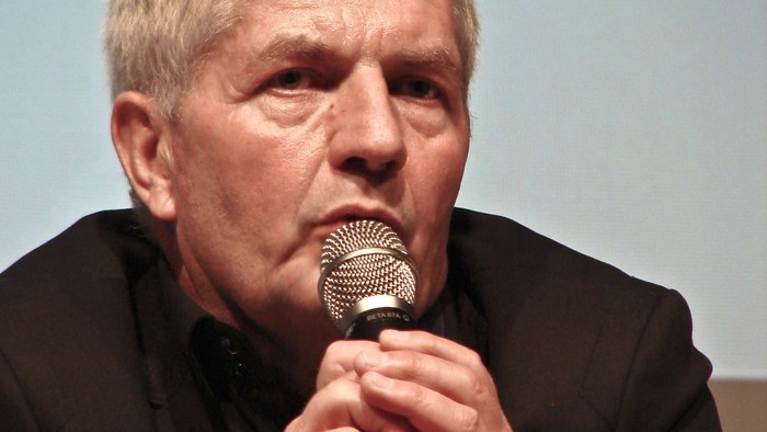 Mann hält Mikrofon und spricht