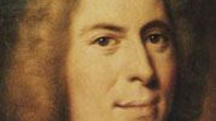 Das Bild zeigt einen Mann mit langem Haar und einem Kragen.