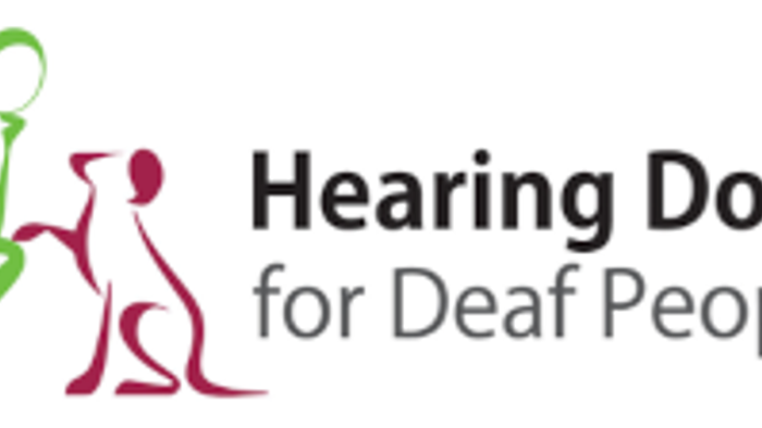 Logo for Hearing Dogs for Deaf People, featuring stylized dog and person icons.