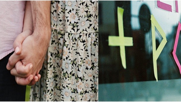 Ein Paar hält sich an den Händen, bunte Klebestreifen an einer Glasfläche