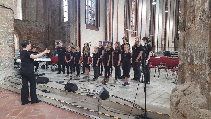 Ein Chor proben in einer Kirche unter der Leitung eines Dirigenten