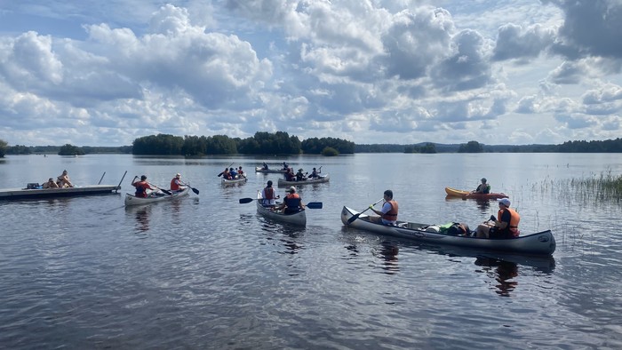 Jugendliche in Kanus auf einem See bei einer evangelischen Jugendfahrt nach Schweden.