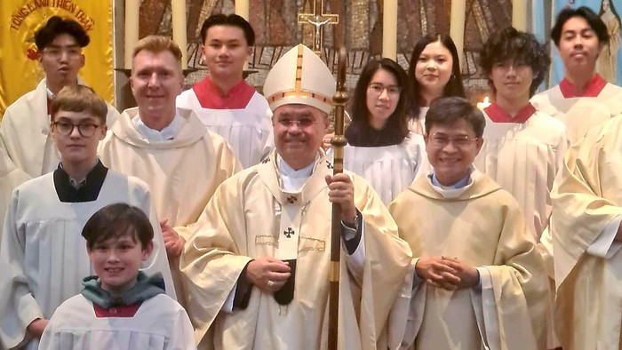 Eine Gruppe von Geistlichen und Kindern posiert in einer Kirche