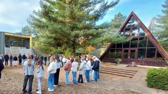 Ein Gruppe Jugendlicher steht vor einer Kapelle
