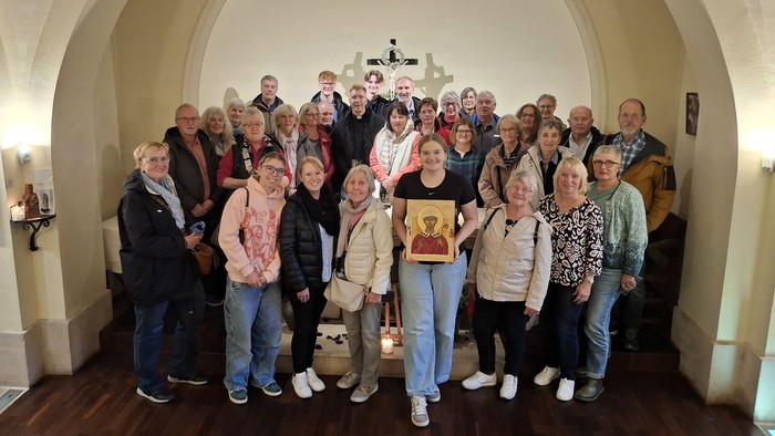 Gruppe von Personen, die drinnen für ein Foto posiert.