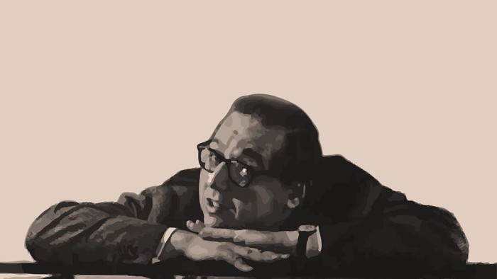 Georg Kreisler lehnt auf seinen Armen auf einem Klavier