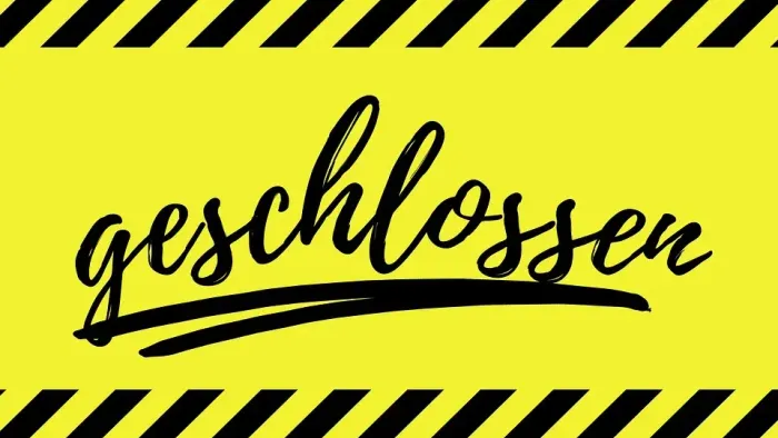 Gelbes Warnschild mit schwarz-weißem Muster und der Aufschrift 