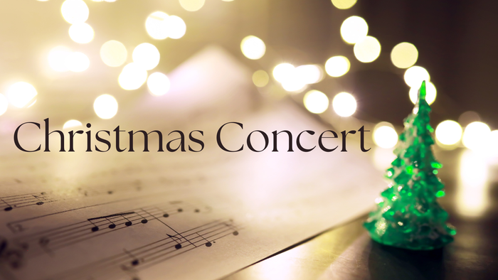 Christmas Concert sign with sheet music and small Christmas tree