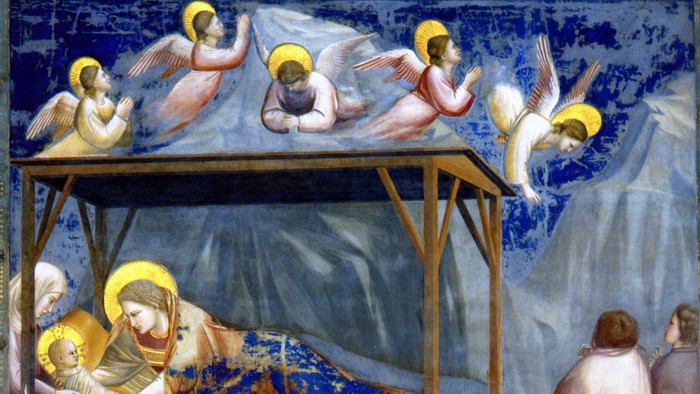 Religiøst maleri, der afbilder juleevangeliet med engle, Maria, Josef og Jesusbarnet.