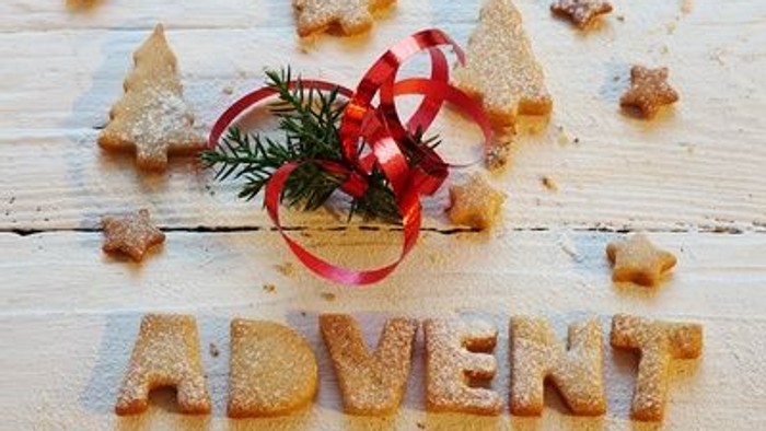 Weihnachtliche Kekse in Form von Tannenbäumen und Sternen mit Zucker bestreut