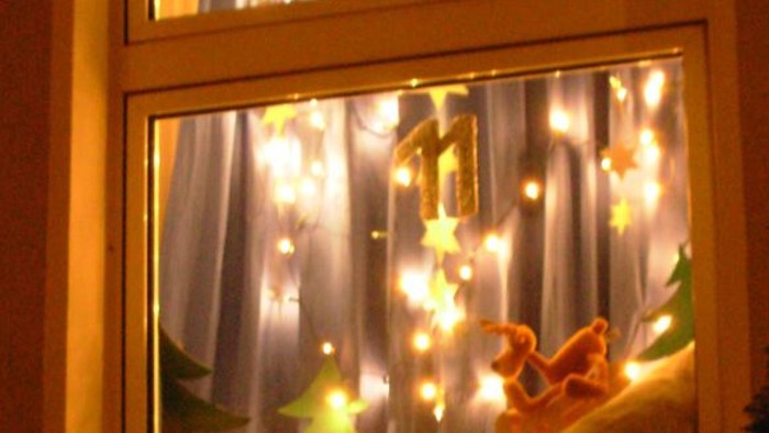 Weihnachtliche Fensterdekoration mit Lichtern und Teddybären