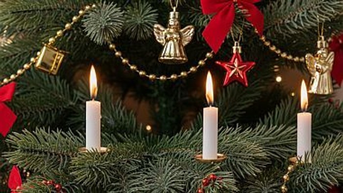 Ausschnitt eines Weihnachtsbaumes, auf dem man Weihnachtsschmuck und Kerzen sieht