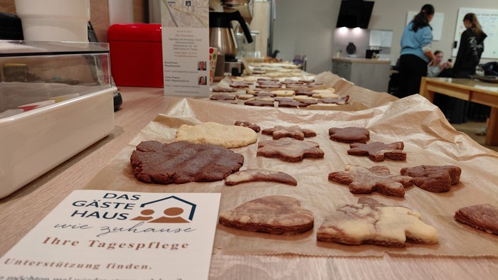 Tisch mit verschiedenen Backwaren und einem Schild auf Deutsch