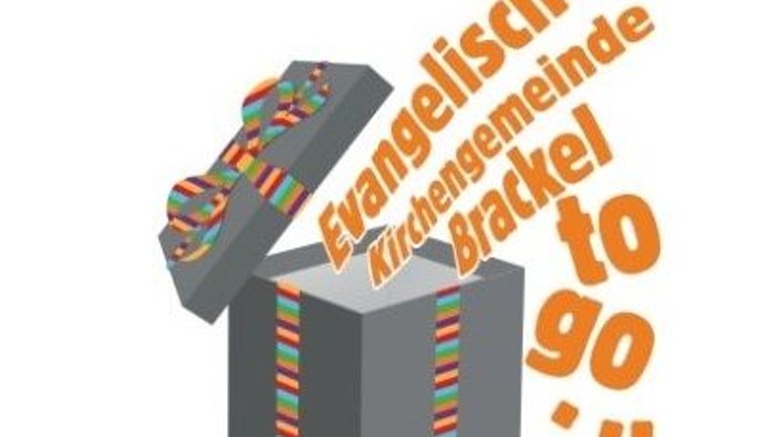 Das Bild zeigt eine geöffnete Geschenkbox mit bunten Streifen und deutschem Text.