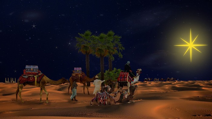 Eine Krippe in der Wüste bei Nacht, mit Sternenhimmel und Kamelen