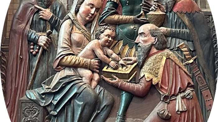Religious sculpture depicts the Adoration of the Magi with figures in elaborate robes.