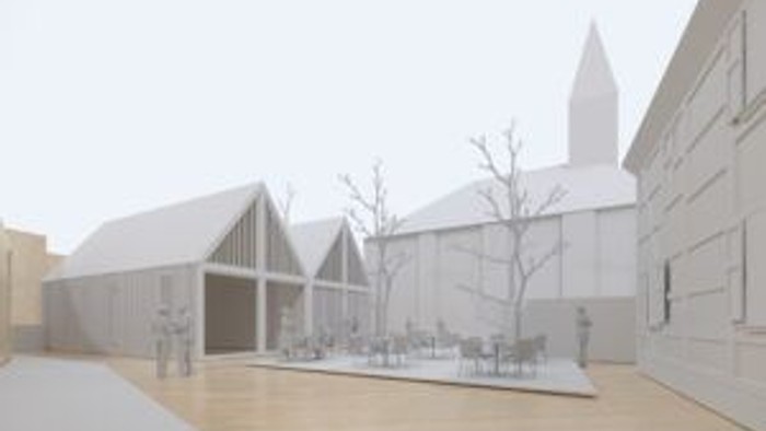 Moderner Innenhof mit minimalistischer Architektur, weißen Strukturen, Sitzgelegenheiten im Freien und schneebedeckten Dächern.