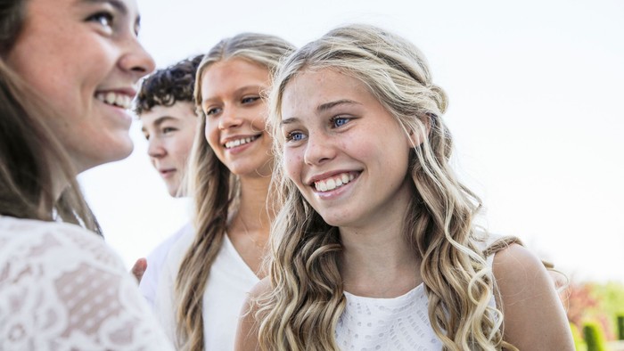 En gruppe unge kvinder smiler og ser glade ud.