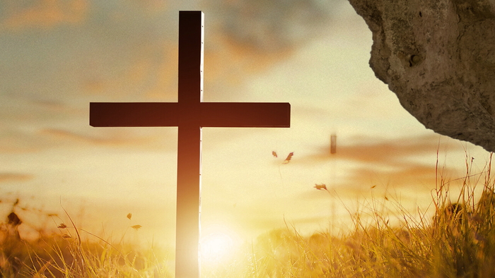 Das Bild zeigt ein Kreuz vor einem Sonnenaufgang mit Text in Deutsch