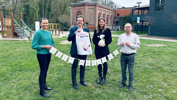 Pfarrerin Leska Randisi, Superintendent Henning Waskönig, Pfarrerin Maria Hinsenkamp und Pfarrer Marcus Tyburski zeigen mit der Wiese auf dem Elbersgelände eine Location von "Einfach heiraten" im Evangelischen Kirchenkreis Hagen.