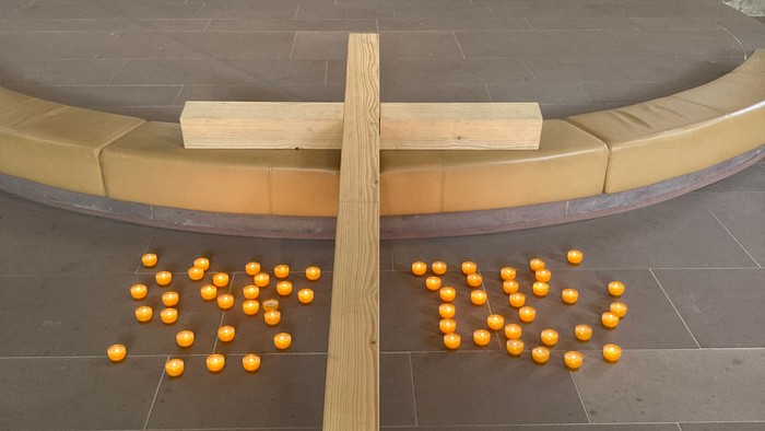 Holzkreuz mit Orangen in Kirchenraum
