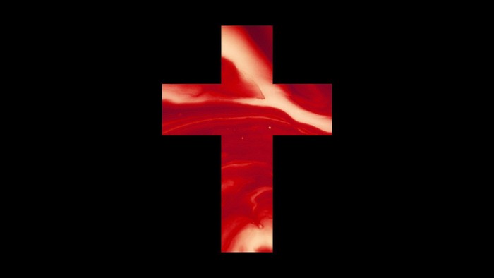A red cross with a glowing effect on a black background.
