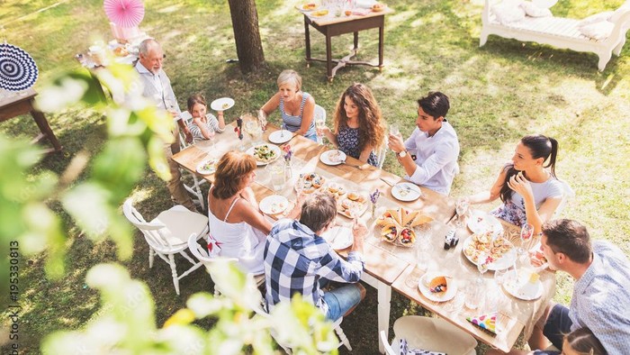 Family enjoying outdoor meal together.
