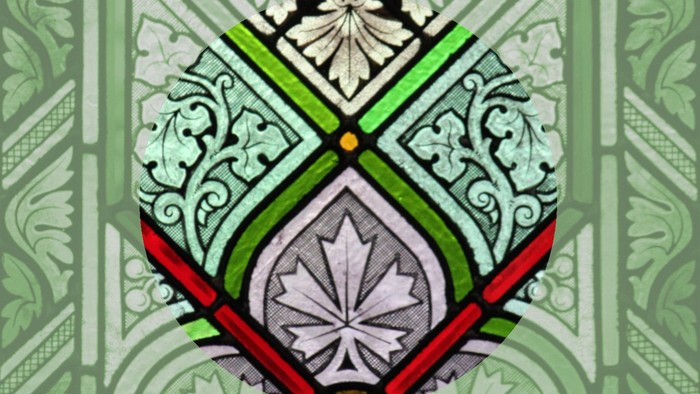 Das Bild zeigt ein filigranes Wappen mit grünen und roten Akzenten auf weißem Hintergrund.
