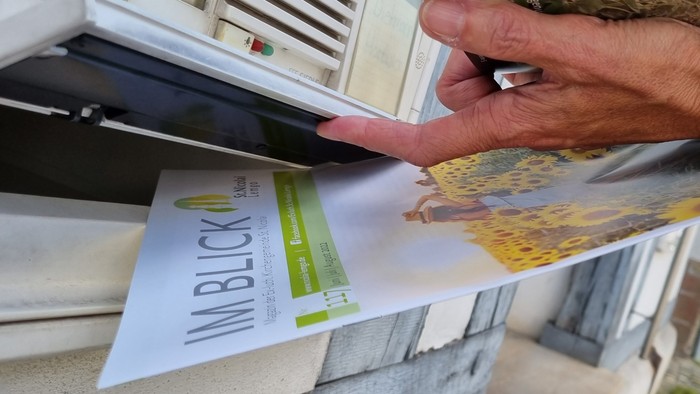 Person steckt Brief in den Briefkasten Nr. 16