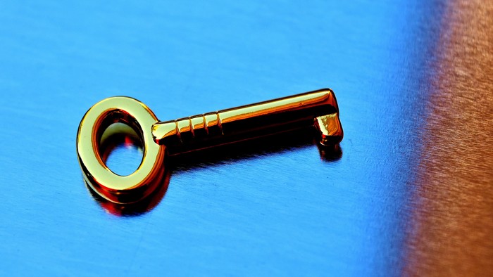 A small key on a wooden surface