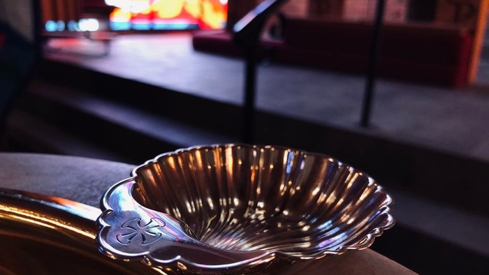 Silver shell-shaped ashtray on a table