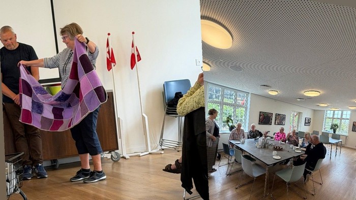 Fællesskabsarrangement med mennesker, der deltager i aktiviteter, laver håndværk og hygger sig i et rummeligt indendørs lokale.