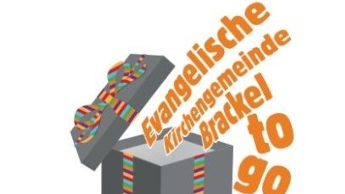Das Bild zeigt eine geöffnete Geschenkbox mit bunten Streifen und deutschem Text.