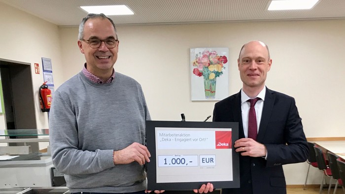 Zwei Männer halten ein Schild mit 