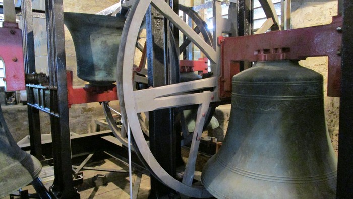 Large bells and machinery in a tower.