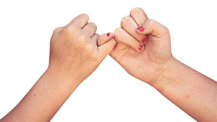 Two hands with red nail polish making a heart shape against black background