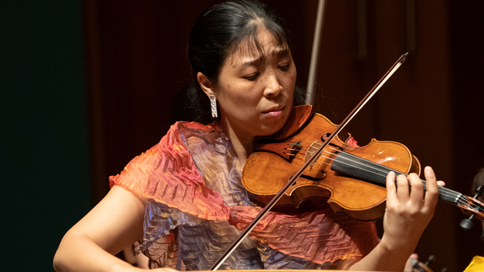 Kvinde spiller violin på scene
