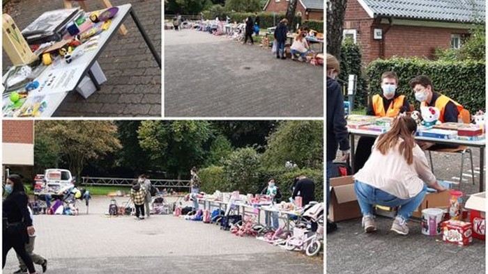 Das Bild zeigt verschiedene Aktivitäten auf einem Freiluftmarkt, darunter ein buntes Rad, einen Informationsstand und Menschen, die sich umstöbern.