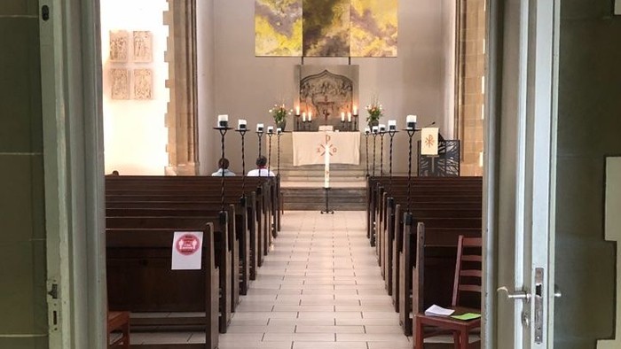 Die Kirche mit Holzstühlen und einem Altar am Ende.
