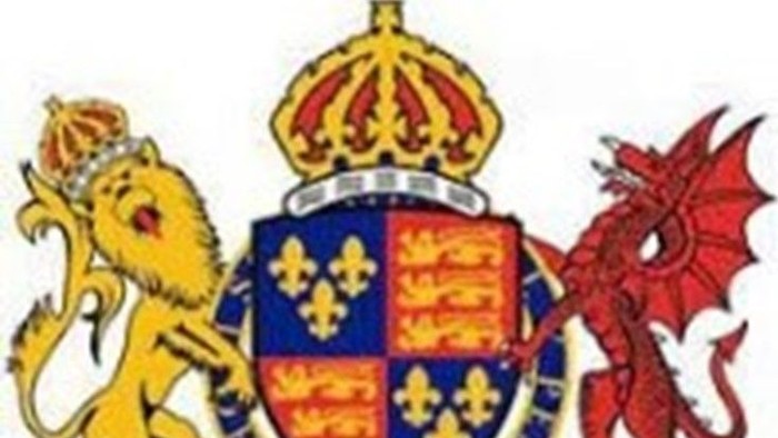 Royal coat of arms with lion, shield, and dragon, crowned with Latin motto