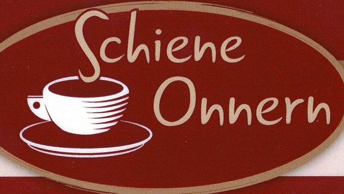Das Bild zeigt ein Kaffeetassen-Logo mit dem Text "Schiene Onnern".