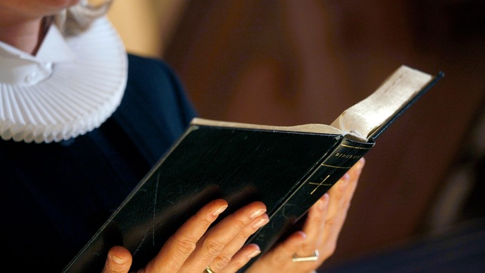 En person læser et håndskrevet bog.