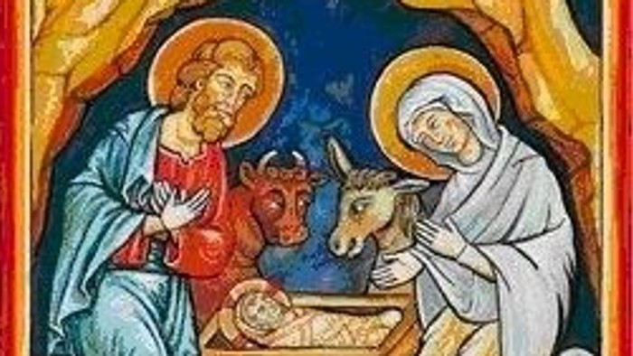 En traditionel krybbescene, der viser Jesu fødsel med Maria, Josef og dyrene i en krybbe under en stjerne.