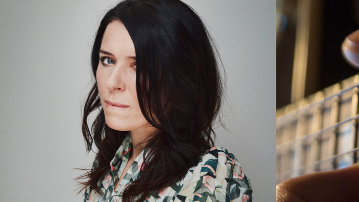 En kvinde med mørkt hår og en blomstermønstret blouse, samt et tæt opkørsel af en bjælke med håndtag.