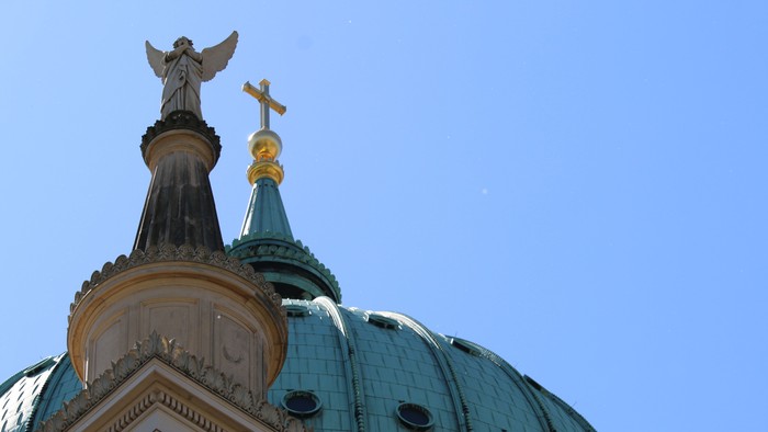 Das Bild zeigt eine Kuppel mit Engel und Kreuz.