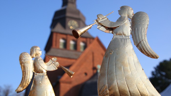 Engelsfiguren vor Kirche spielen Flöten