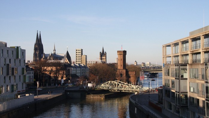 Die Stadtlandschaft zeigt einen Fluss mit Brücke und historischen Gebäuden.