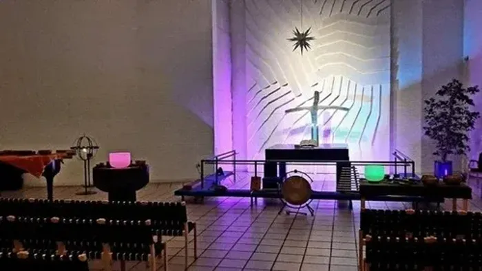 Kirkeinteriør med lysspektakel og alter.